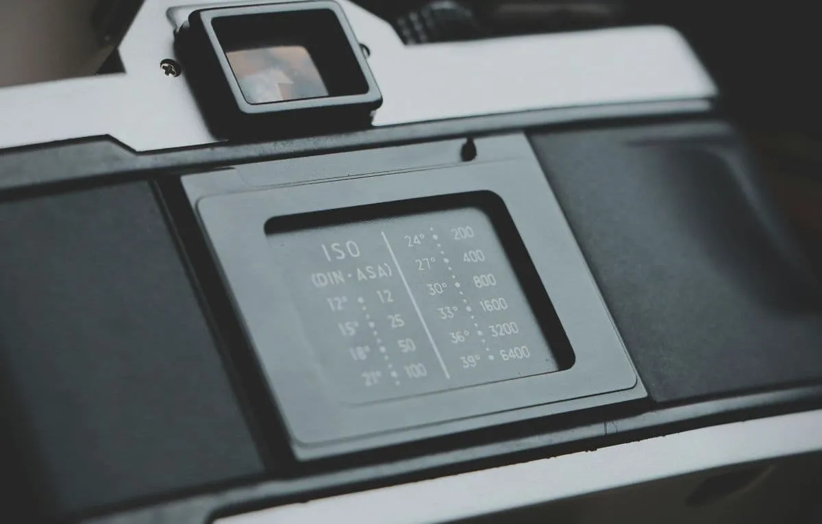 Close-up of ISO settings on a film camera, illustrating sensitivity to light in photography.